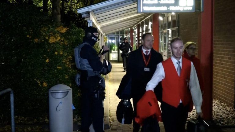 Police oversee the evacuation of staff and passenger at the airport in Hamburg, northern Germany on November 4, 2023. Air traffic at Hamburg airport remained suspended Sunday over a suspected hostage situation on the tarmac involving a child, local authorities said.<br />A gunman rammed his car through the security area onto the apron where planes are parked on Saturday evening, firing two shots in the air and flinging two burning bottles out of the vehicle, police said. (Photo by NEWS5 / DESK / NEWS5 / AFP)