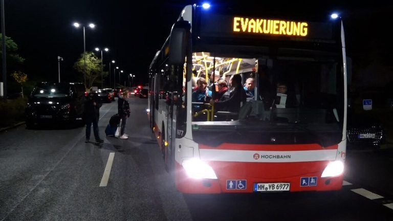 Staff and passengers are being evacuated by bus at the airport in Hamburg, northern Germany on November 4, 2023. Air traffic at Hamburg airport remained suspended Sunday over a suspected hostage situation on the tarmac involving a child, local authorities said.<br />A gunman rammed his car through the security area onto the apron where planes are parked on Saturday evening, firing two shots in the air and flinging two burning bottles out of the vehicle, police said. (Photo by NEWS5 / DESK / NEWS5 / AFP)