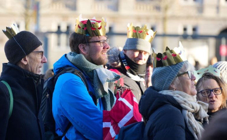 Members of the public wear fake crowns at Christiansborg Palace Square ahead of the proclamation of abdication of Denmark's Queen Margrethe II, in Copenhagen on January 14, 2024. Denmark turns a page in its history on January 14 when Queen Margrethe abdicates and her son becomes King Frederik X, with more than 100,000 Danes expected to turn out for the unprecedented event. (Photo by Emil Helms / Ritzau Scanpix / AFP) / Denmark OUT