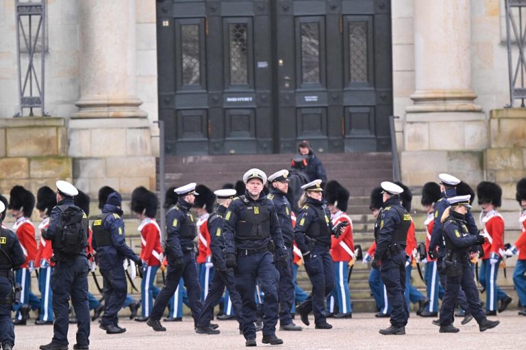 Police officers gather at the Christiansborg Palace Square as the Royal Life Guards is seen in the the background ahead of the proclamation of abdication of Denmark's Queen Margrethe II, in Copenhagen, Denmark, on January 14, 2024. Denmark turns a page in its history on January 14 when Queen Margrethe abdicates and her son becomes King Frederik X, with more than 100,000 Danes expected to turn out for the unprecedented event. (Photo by Nils Meilvang / Ritzau Scanpix / AFP) / Denmark OUT