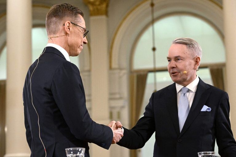 National Coalition Party (NCP) presidential candidate Alexander Stubb (L) and Green Party backed candidate for a nonpartisan constituency association Pekka Haavisto shake hands after results were announced during an election night event at the Helsinki City Hall in Helsinki, Finland, on February 11, 2024. Former conservative prime minister and favourite Alexander Stubb had an early lead over rival Pekka Haavisto in the Finnish presidential election's second round Sunday, from votes cast in advance. (Photo by Heikki Saukkomaa / Lehtikuva / AFP) / Finland OUT