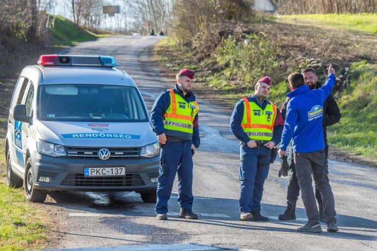 Hungarian police officers close the road near the crash site where a vehicle taking part in the Esztergom Nyerges Rally veered off from the road on March 24, 2024, near Bajot, 55kms away from Budapest. Four people were killed and several others injured when a vehicle competing in a Hungarian rally on March 24 afternoon skidded off the road and crashed into spectators, authorities said. According to a police statement, a vehicle taking part in the Esztergom Nyerges Rally in northern Hungary, for reasons yet unclear, veered off the road and crashed into spectators. (Photo by FERENC ISZA / AFP)