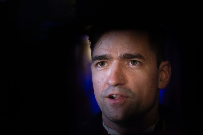 Martin Sellner, former spokesman of the far-right Identitarian movement, speaks to journalists in front of the Hofburg Palace in Vienna upon arrival at the so-called Akademikerball (Academics dance ball) organized by the far-right Austrian Freedom Party (FPOe) on February 16, 2024. For several years, there have been annual demonstrations and fierce criticism of the ball, which were justified by the participation of high-ranking representatives of far-right European parties. (Photo by Alex HALADA / AFP)