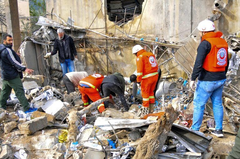 People inspect destruction at the site of an overnight Israeli airstrike in Habariyeh near the Israeli border on March 27, 2024. A Lebanese militant organisation closely linked to Palestinian group Hamas said on March 27 that seven people were killed in an overnight strike in south Lebanon. Several militant groups in Lebanon operate health centres and emergency response operations. (Photo by Rabih DAHER / AFP)