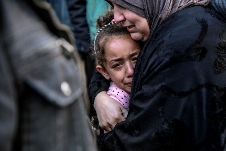 TOPSHOT - A Palestinian woman holds a child as they mourn their relatives killed in Israeli bombardment in front of the morgue of the Al-Shifa hospital in Gaza City on March 15, 2024, amid the ongoing conflict between Israel and the Palestinian Hamas movement. (Photo by AFP)