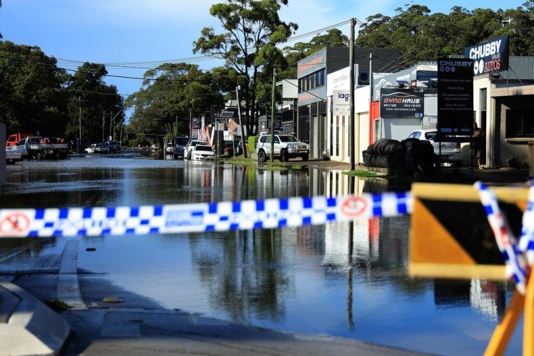 A flooded road is seen in the Sydney suburb of North Narrabeen on April 6, 2024, after heavy rain hit New South Wales state. Hundreds of Australians were ordered to evacuate their homes in Sydney as torrential rain battered the country's largest city and floodwaters inundated its outskirts. (Photo by Glenn Nicholls / AFP)