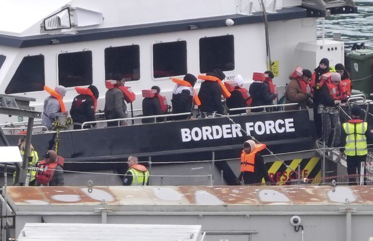 A group of people thought to be migrants are brought in to Dover, Kent, England, from a Border Force vessel following a small boat incident in the Channel, Saturday, March 30, 2024. (Gareth Fuller/PA via AP)