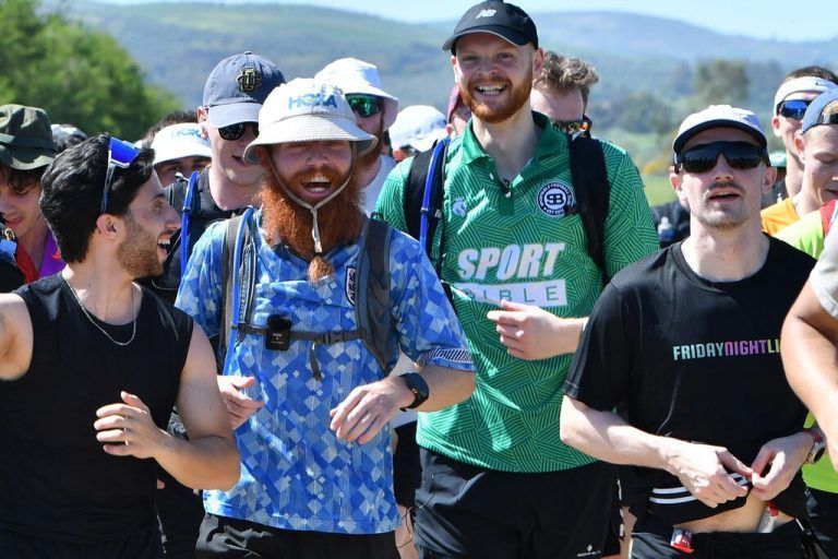 Britain's Russ Cook (C-L) runs, with supporters who joined him for the final leg of the 16,000km challenge to run the length of Africa from South Africa's Cape Agulhas to Tunisia's Cape Angela to raise money for charity, in town of Ghazela, north east of Tunis on April 7, 2024. (Photo by FETHI BELAID / AFP)