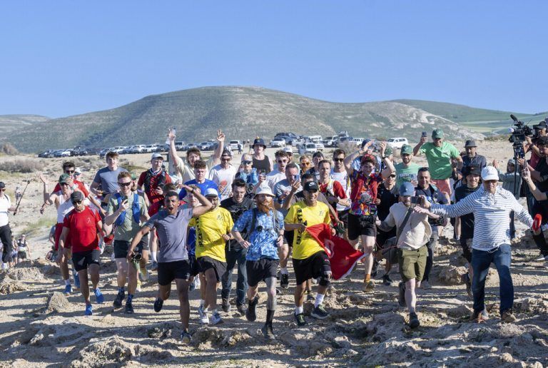 British runner Russ Cook, center, celebrates with supporters after arriving to the finish line in Ras Angela, the most northern point of the African continent, in Tunis, Tunisia, Sunday, April 7, 2024. Cook — known on social media by his nickname, Hardest Geezer — has run more than 16,000 kilometers (10,000 miles), from the south to north of Africa, in 352 days. (AP Photo/The Snapshot People LTD)