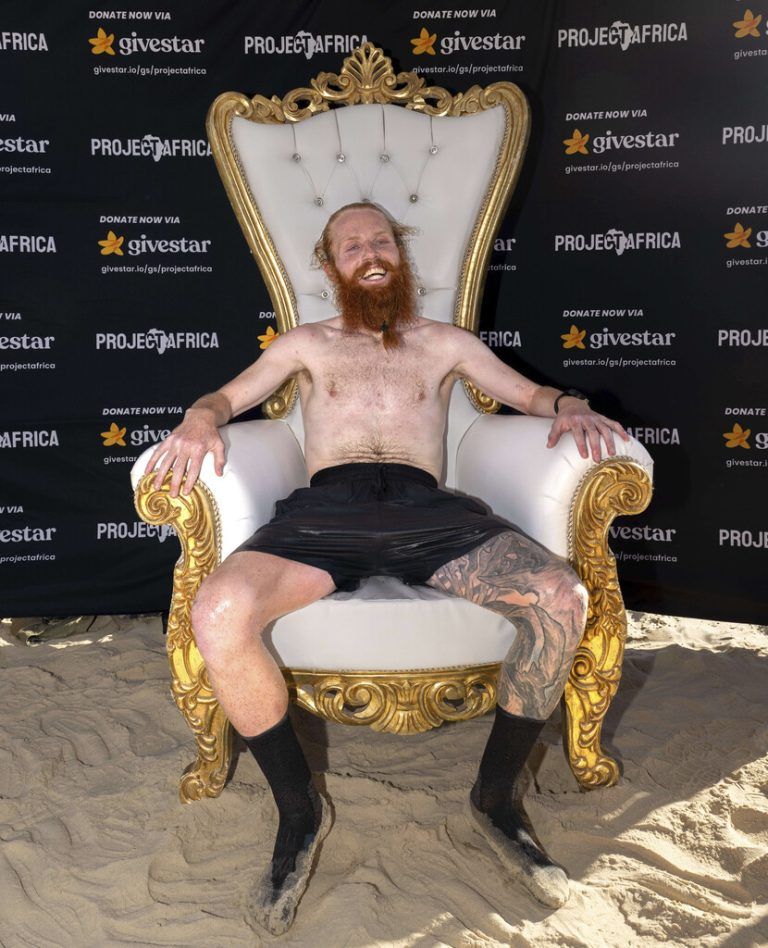 British runner Russ Cook sits after arriving to the finish line in Ras Angela, the most northern point of the African continent, in Tunis, Tunisia, Sunday, April 7, 2024. Cook — known on social media by his nickname, Hardest Geezer — has run more than 16,000 kilometers (10,000 miles), from the south to north of Africa, in 352 days. (AP Photo/The Snapshot People LTD)
