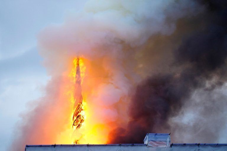 This photograph shows flames engulfing the Copenhagen's Stock Exchange building, in Copenhagen, on April 16, 2024. (Photo by Ida Marie Odgaard / Ritzau Scanpix / AFP) / Denmark OUT