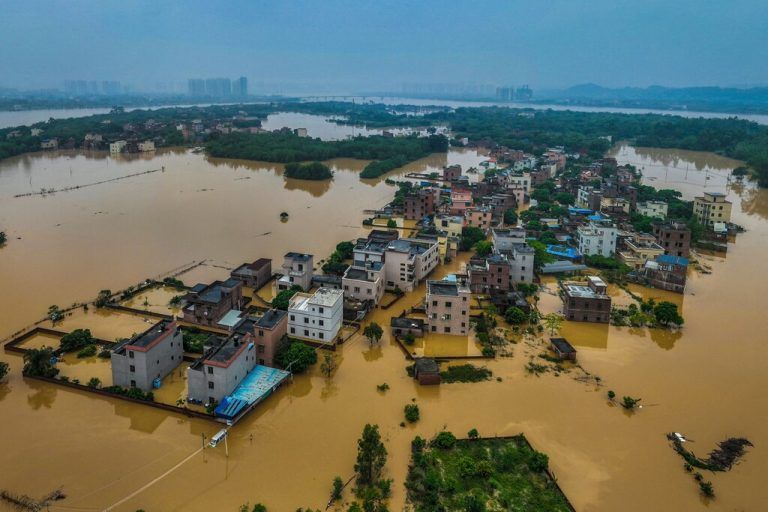 TOPSHOT - This aerial photograph taken on April 22, 2024 shows flooded buildings and streets after heavy rains in Qingyuan, in southern China's Guangdong province. More than 100,000 people have been evacuated due to heavy rain and fatal floods in southern China, with the government issuing its highest-level rainstorm warning for the affected area on April 23. (Photo by AFP) / China OUT