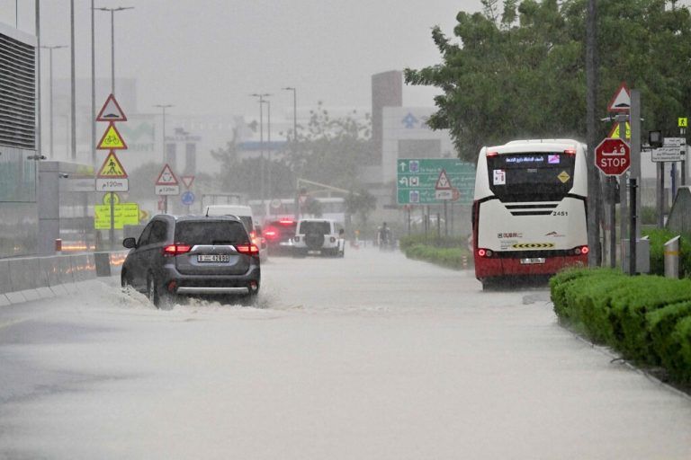 Vehicles drive on a flooded road during torrential rain in the Gulf Emirate of Dubai on April 16, 2024. Torrential rains and high winds lashed parts of the Gulf on April 16, as the death toll from storms in Oman rose to 18, many of them children. Flights were cancelled in Dubai, the region's financial hub, while schools were shut in the United Arab Emirates and Bahrain. (Photo by Giuseppe CACACE / AFP)