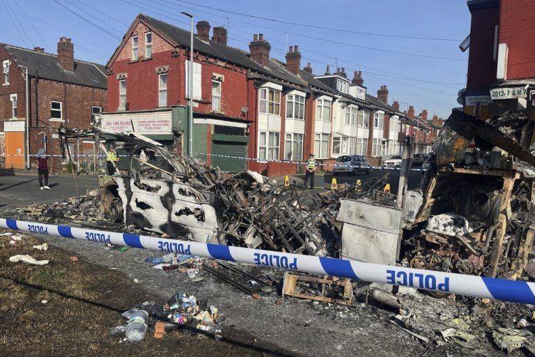 A burnt out car in the Leeds suburb of Harehills, Friday July 19, 2024, following an outbreak of disorder on Thursday evening. Officials in the northern English city of Leeds say order has been restored after a night of unrest that began when police and local government workers intervened in a “family incident” and residents poured into the streets in protest. (Katie Dickinson/PA via AP)