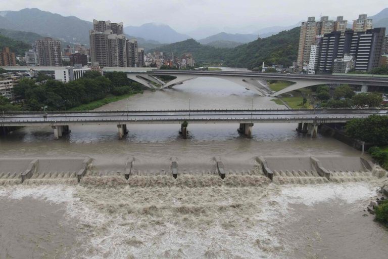 An aerial view shows Xindian river’s rising water level at New Taipei City as typhoon Gaemi passes Taiwan on July 25,  2024. (Photo by Sam Yeh / AFP)
