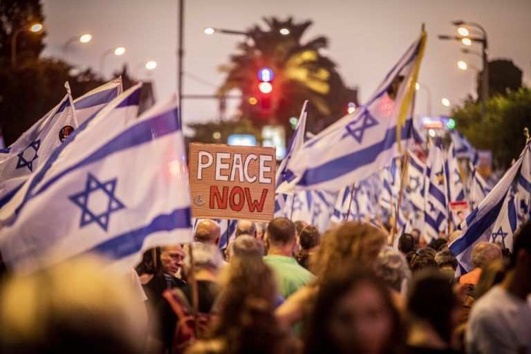 Anti Government Protest in Tel Aviv A sign that readsÓPeace NowÓ is seen among a sea of Israeli flags during a demonstration in Tel Aviv, Saturday, June 22 2024. Tens of thousands anti-government protesters demonstrated in Tel Aviv, calling for Israel to press ahead with a deal to release hostages held by Hamas in Gaza, to end the war and for the ouster of Prime Minister Benjamin Netanyahu and early elections. Photo by Eyal Warshavsky. Tel Aviv Israel Copyright: xEyalxWarshavskyx