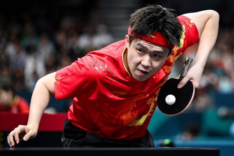 China's Wang Chuqin plays a return to Sweden's Truls Moregard during their men's table tennis singles round of 32 at the Paris 2024 Olympic Games at the South Paris Arena in Paris on July 31, 2024. (Photo by JUNG Yeon-je / AFP)