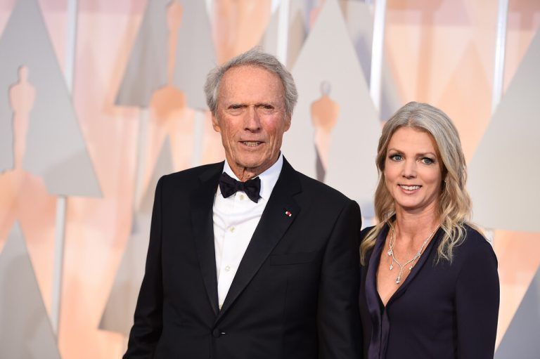 Clint Eastwood, left, and Christina Sandera arrive at the Oscars on Sunday, Feb. 22, 2015, at the Dolby Theatre in Los Angeles. (Photo by Jordan Strauss/Invision/AP)