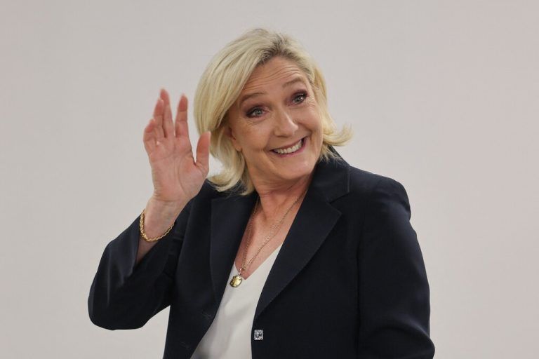 CORRECTION / TOPSHOT - Head of French far-right Rassemblement National (RN) parliamentary group at the National Assembly Marine Le Pen waves before heading into a booth to mark her ballot at in the first round of parliamentary elections  in Henin-Beaumont, North of France, on June 30, 2024. A divided France is voting in high-stakes parliamentary elections that could see the anti-immigrant and eurosceptic party of Marine Le Pen sweep to power in a historic first. The candidates formally ended their frantic campaigns at midnight June 28, with political activity banned until the first round of voting. (Photo by FRANCOIS LO PRESTI / AFP) / “The erroneous mention[s] appearing in the metadata of this photo by Francois LO PRESTI has been modified in AFP systems in the following manner: [Marine Le Pen] instead of [Marie-Caroline Le Pen]. Please immediately remove the erroneous mention[s] from all your online services and delete it (them) from your servers. If you have been authorized by AFP to distribute it (them) to third parties, please ensure that the same actions are carried out by them. Failure to promptly comply with these instructions will entail liability on your part for any continued or post notification usage. Therefore we thank you very much for all your attention and prompt action. We are sorry for the inconvenience this notification may cause and remain at your disposal for any further information you may require.”
