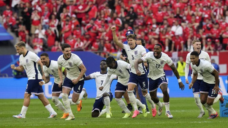 England players celebrate after Trent Alexander-Arnold scored the winning goal during the penalty shootout of a quarterfinal match between England and Switzerland at the Euro 2024 soccer tournament in Duesseldorf, Germany, Saturday, July 6, 2024. (AP Photo/Martin Meissner)