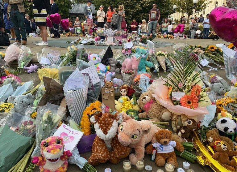 Floral tributes and soft toys are laid following a vigil in Southport, northwest England, on July 30, 2024, a day after a deadly child knife attack. Violent clashes broke out in the northern England town where a knife attack claimed the lives of three children, with around 100 protesters lighting fires and battling police. A 17-year-old male suspect from a nearby village arrested shortly after the incident remained in custody, police added, as they warned against speculating about his identity or details of the investigation. (Photo by Roland LLOYD PARRY / AFP)