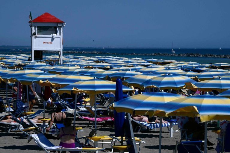 People enjoy the beach near Rome where temperatures reach 37 degrees celsius on July 10, 2024 in Fiumicino. (Photo by Filippo MONTEFORTE / AFP)
