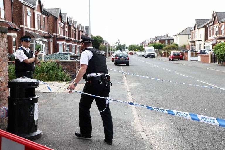 Police officers stand guard behind a cordon on Hart Street in Southport, northwest England, on July 29, 2024, following a knife attack. A suspected knife attack in northern England left at least eight people injured, believed to include children, emergency services said. (Photo by Darren Staples / AFP)