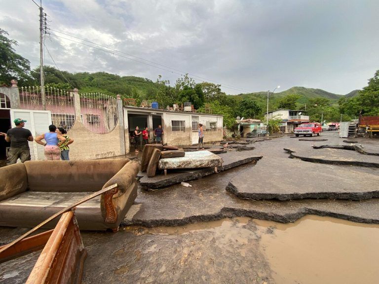 Residents try to recover their belongings from their flooded houses after a river swelled due to heavy rains following the passage of Hurricane Beryl on the road from Cumana to Cumanacoa, Sucre State, Venezuela, on July 2, 2024. Hurricane Beryl churned towards Jamaica Tuesday after killing at least five people and causing widespread destruction across the southeastern Caribbean, threatening deadly winds and storm surge as it approached. (Photo by Victor GONZALEZ / AFP)