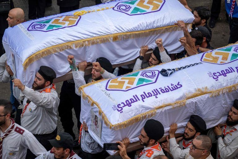 Scouts carry the coffins of two children, Hassan and Amira Muhammed Fadallah, during their funeral a day after they were killed in an Israeli strike on a building in Beirut's southern suburbs, on July 31, 2024. Lebanon's health ministry said that three people, including the two children, were killed in the Israeli strike on Beirut's southern suburbs that also left 74 injured on July 30, which came days after Israel vowed to retaliate over deadly rocket fire from Lebanon on the occupied Golan Heights. (Photo by Khaled DESOUKI / AFP)