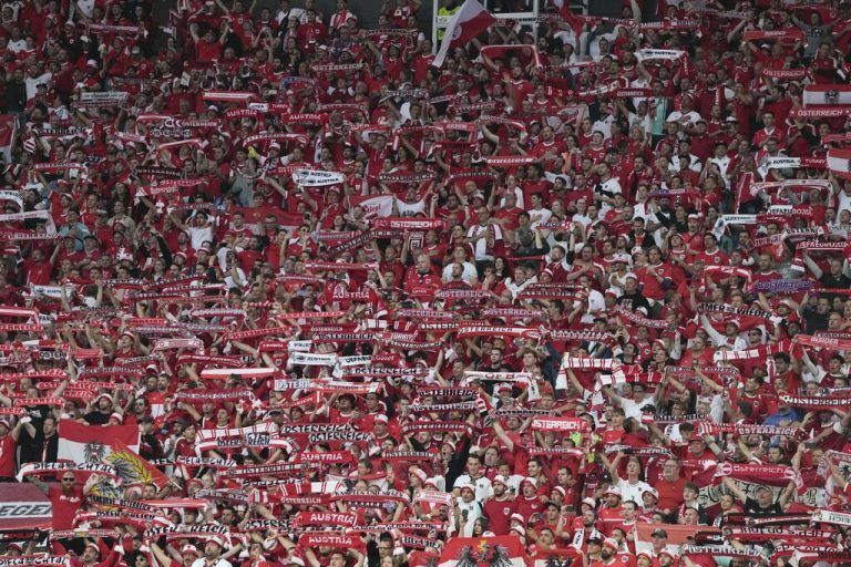 Soccer fans cheer their teams during a round of sixteen match between Austria and Turkey at the Euro 2024 soccer tournament in Leipzig, Germany, Tuesday, July 2, 2024. (AP Photo/Thanassis Stavrakis)