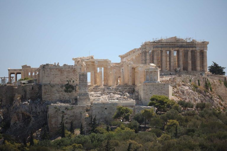 This photograph shows a general view of the ancient temple of the Parthenon on the Acropolis hill in Athens on July 17, 2024. The Greek Ministry of Culture announces a precautionary measure to ensure the safety of visitors during the heatwave, restricting access to the site between 12pm and 5pm. (Photo by Aris Oikonomou / AFP)
