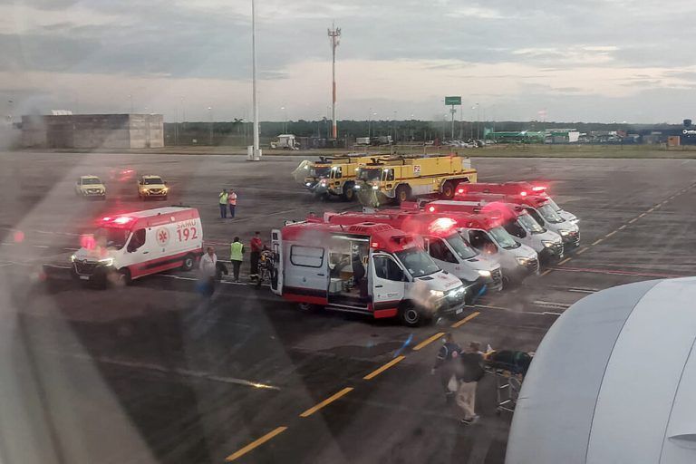 This UGC picture taken on July 1, 2024 and released as a courtesy by passenger Claudio Fernandez Arbes shows ambulances next to an Air Europa Boeing 787-9 Dreamliner after it made an emergency landing in Natal, in northern Brazil, on July 1, 2024, after hitting strong turbulence on its way from Madrid to Montevideo. At least seven people were injured Monday during the flight prompting an emergency landing in Brazil, the airline said. The plane, with 325 people on board, was diverted in the early morning hours to the airport of Natal in northeastern Brazil on its way to the Uruguayan capital, the Spanish company said. (Photo by Claudio FERNANDEZ ARBES / UGC / AFP) / RESTRICTED TO EDITORIAL USE – MANDATORY CREDIT « AFP PHOTO / Courtesy of Claudio FERNANDEZ ARBES» - NO MARKETING NO ADVERTISING CAMPAIGNS – DISTRIBUTED AS A SERVICE TO CLIENTS