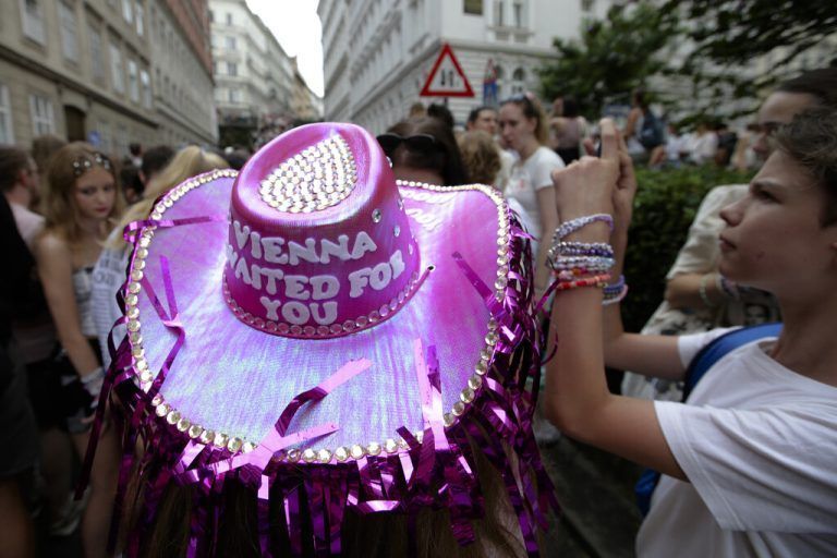 A person wears a purple head as Swifties gather in the city centre in Vienna on Thursday, Aug.8, 2024. Organizers of three Taylor Swift concerts in the stadium in Vienna this week called them off on Wednesday after officials announced arrests over an apparent plot to launch an attack on an event in the Vienna area such as the concerts. (AP Photo/Heinz-Peter Bader)