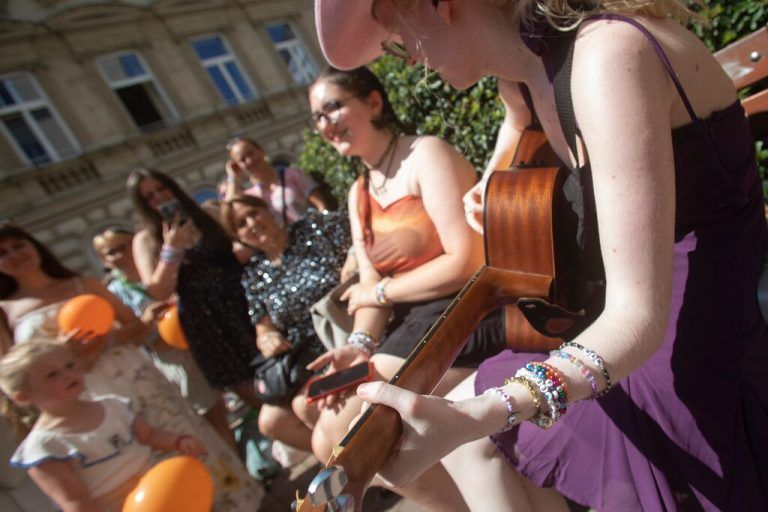 Fans of US singer Taylor Swift - swifties - stand and sing around the Swiftie Tree in Cornelius Strasse street in Vienna, Austria, on August 8, 2024. A 19-year-old Islamic State sympathiser planned a suicide attack at a Taylor Swift concert in Vienna designed to kill many people, the country's intelligence agency said. Austrian authorities detained two suspects for allegedly plotting to attack this week's Vienna concerts by the US star, which organisers cancelled at the last minute. (Photo by Alex HALADA / AFP)
