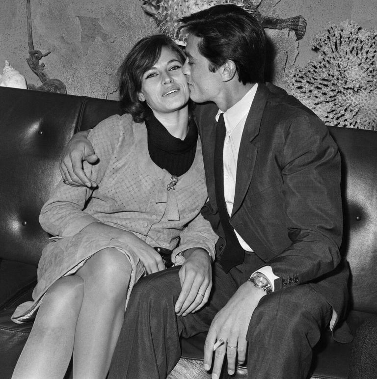 (FILES) French actor Alain Delon (R) kisses his wife Nathalie upon his arrival at Orly airport in Orly, France, on April 28, 1965. French film legend Alain Delon has died at the age of 88, his three children told AFP in a statement on August 18, 2024, following a battle with ill health. (Photo by AFP)