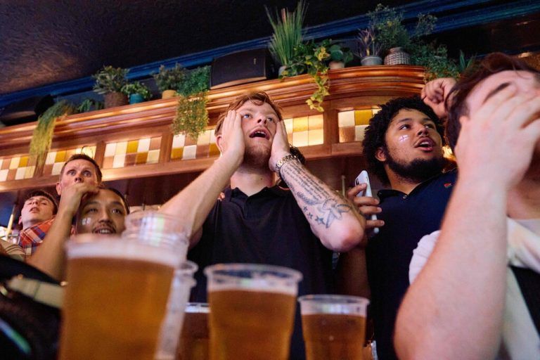 England fans react as they watch a live screening of the UEFA Euro 2024 final football match between Spain and England being played in Berlin, inside a pub in central London on July 14, 2024. England are hoping to end their 58-year wait to win a men's major international tournament when they take on an outstanding Spain team in the final of Euro 2024. (Photo by BENJAMIN CREMEL / AFP)