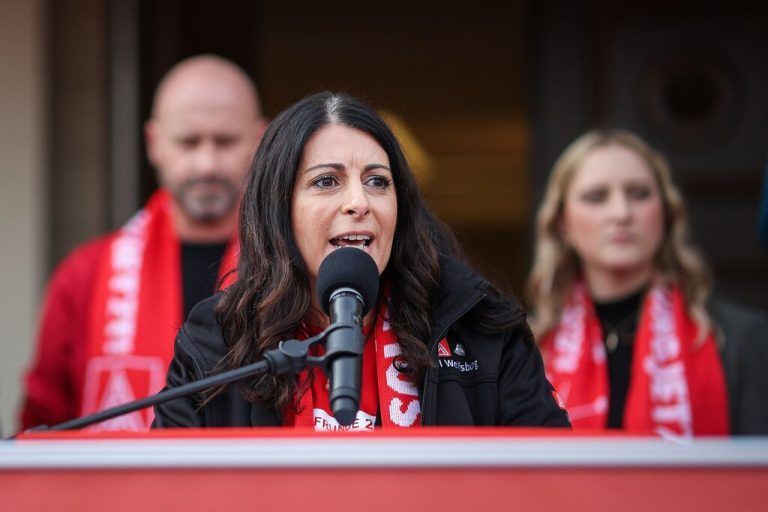 Daniela Cavallo, chairwoman of the General and Group Works Council of the Volkswagen Group, addresses members of the IG Metall metalworkers union as they demonstrate on September 25, 2024 in front of Schloss Herrenhausen Palace in Hanover, northern Germany, where talks between unions and the Volkswagen management started following an announcement of German carmaker Volkswagen (VW) that drastic cost-cutting measures are needed to keep the carmaker competitive. After Volkswagen's bombshell announcement earlier in September 2024 that it could close factories in Germany for the first time, company management and unions will begin tense talks on a new pay deal. After Volkswagen's bombshell announcement earlier in September 2024 that it could close factories in Germany for the first time, company management and unions will begin tense talks on a new pay deal. Volkswagen has repeatedly stressed that its costs are excessive and profit margins too low, particularly at its core VW brand. (Photo by RONNY HARTMANN / AFP)