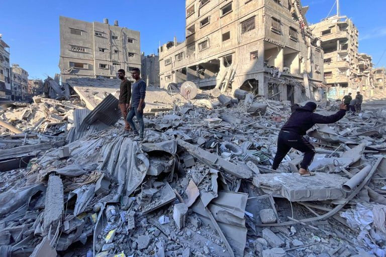 EDITORS NOTE: Graphic content / TOPSHOT - People check the rubble of a building hit in an overnight Israeli strike in Beit Lahya in the northern Gaza Strip on November 17, 2024. Since October 6, the Israeli military has mounted a sweeping air and land assault on northern Gaza, initially focused on the Jabalia area, describing it as an operation aimed at preventing Hamas militants from regrouping. (Photo by AFP)