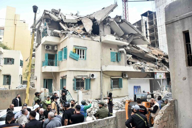 Residents, rescuers and journalists gather in front of a building targeted by an Israeli strike in Beirut’s Ras al-Nabaa neighbourhood on November 17, 2024, where a Lebanese security source said a Hezbollah official was killed. (Photo by Fadel ITANI / AFP)