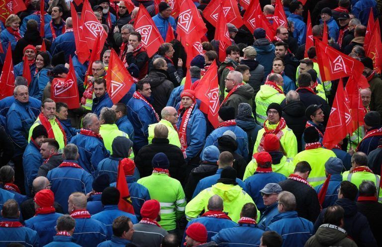 Employees of German car maker Volkswagen (VW) demonstrate outside the VW commercial cars plant on December 2, 2024 in Hanover, northern Germany, as thousands of Volkswagen workers go on strike all over Germany in an escalating industrial dispute at the crisis-hit German auto giant with thousands of jobs at stake. VW has been hit hard by high manufacturing costs at home, a stuttering shift to electric vehicles and tough competition in key market China. It has announced a plan to cut billions of dollars in costs. (Photo by Ronny HARTMANN / AFP)