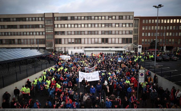 Employees of German car maker Volkswagen (VW) demonstrate outside the VW commercial cars plant on December 2, 2024 in Hanover, northern Germany, as thousands of Volkswagen workers go on strike all over Germany in an escalating industrial dispute at the crisis-hit German auto giant with thousands of jobs at stake. VW has been hit hard by high manufacturing costs at home, a stuttering shift to electric vehicles and tough competition in key market China. It has announced a plan to cut billions of dollars in costs. (Photo by Ronny HARTMANN / AFP)