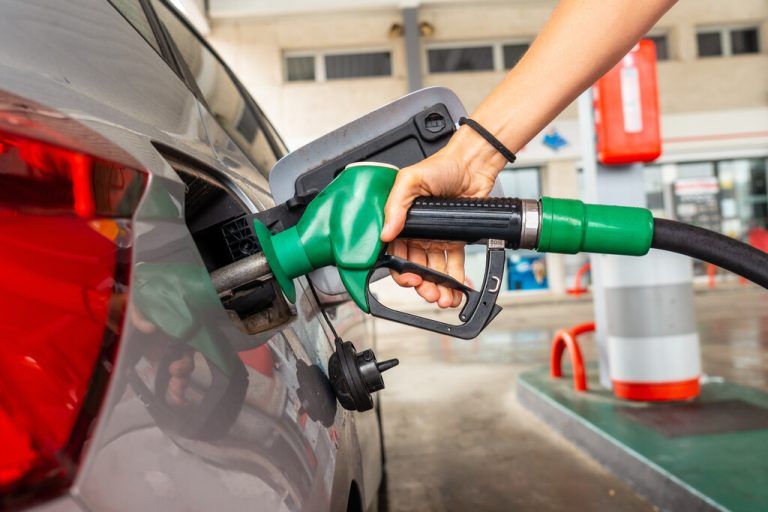 Woman refueling gasoline at gas station in fuel crisis after war conflict